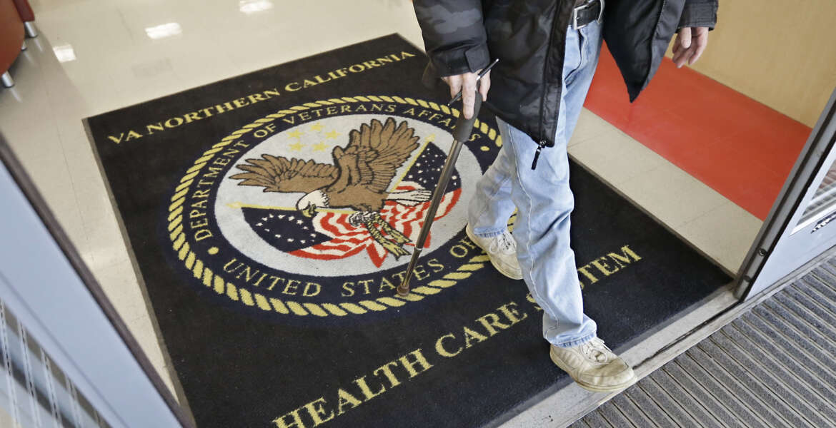 FILE - In this April 2, 2015, file photo, a visitor leaves the Sacramento Veterans Affairs Medical Center in Rancho Cordova, Calif. The number of veterans seeking health care but ending up on waiting lists of one month or more is 50 percent higher now than it was a year ago when a scandal over false records and long wait times wracked the Department of Veterans Affairs, The New York Times reported Saturday, June 20, 2015, online ahead of its Sunday editions. (AP Photo/Rich Pedroncelli, File)