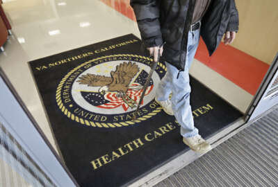 FILE - In this April 2, 2015, file photo, a visitor leaves the Sacramento Veterans Affairs Medical Center in Rancho Cordova, Calif. The number of veterans seeking health care but ending up on waiting lists of one month or more is 50 percent higher now than it was a year ago when a scandal over false records and long wait times wracked the Department of Veterans Affairs, The New York Times reported Saturday, June 20, 2015, online ahead of its Sunday editions. (AP Photo/Rich Pedroncelli, File)