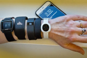 FILE - In this Dec. 15, 2014, file photo, fitness trackers, from left, Basis Peak, Adidas Fit Smart, Fitbit Charge, Sony SmartBand, and Jawbone Move, are posed for a photo next to an iPhone, in New York. Although sales of fitness trackers are strong, many of their owners lose enthusiasm for them once the novelty wears off. (AP Photo/Bebeto Matthews, File)