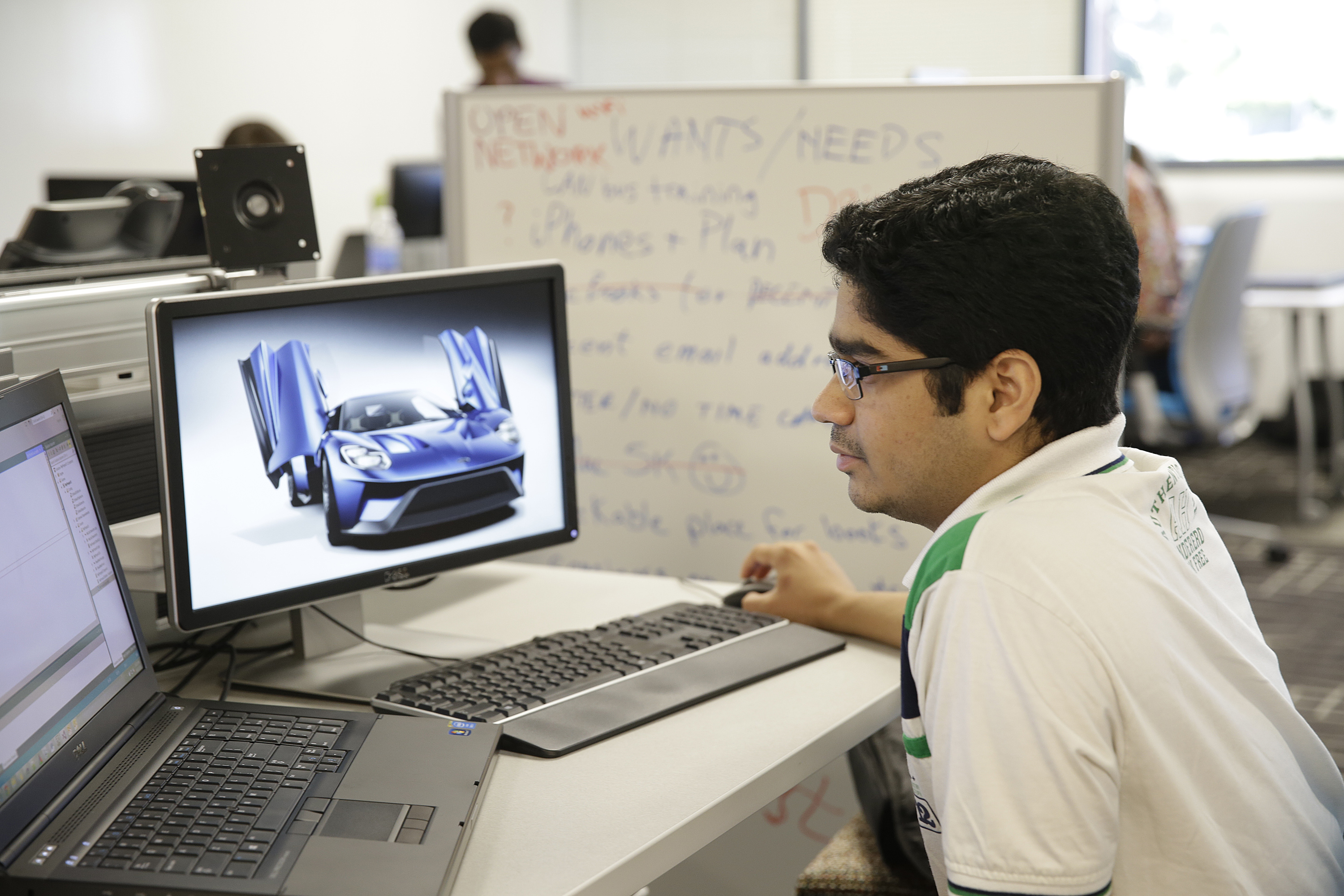 In this photo taken Thursday, Aug. 13, 2015, a research engineer works on image processing at the Ford Motor Company Research and Innovation Center in Palo Alto, Calif. The convergence of cars and technology is blurring the traditional geographical boundaries of both industries. Silicon Valley is dotted with research labs opened by automakers and suppliers, who are racing to develop high-tech infotainment systems and autonomous cars. (AP Photo/Eric Risberg)