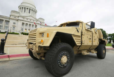 FILE - In this file photo taken May 26, 2015, a prototype of a Lockheed Martin Joint Light Tactical Vehicle is parked in front of the Arkansas state Capitol in Little Rock, Ark. The Department of Defense announced Tuesday, Aug. 25, 2015, that the defense contract to produce the vehicle is going to Wisconsin-based Oshkosh Corp. (AP Photo/Danny Johnston, File)