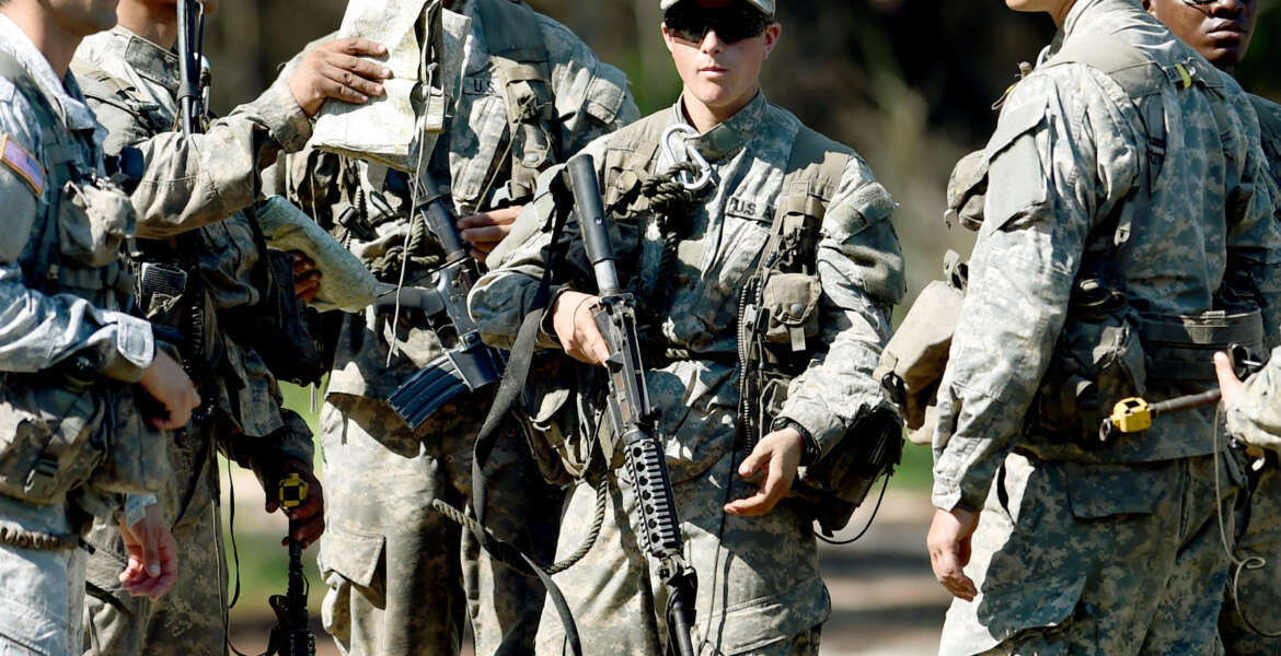 In this photo taken on Aug. 4, 2015, a female Army Ranger stands with her unit during Ranger School at Camp Rudder on Eglin Air Force Base, Fla. According to the Northwest Florida Daily News, she and one other female were the first to complete Ranger training and earn their Ranger tab this week. (Nick Tomecek/Northwest Florida Daily News via AP) MANDATORY CREDIT