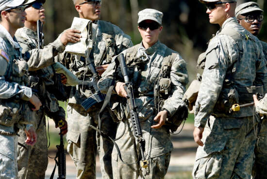 In this photo taken on Aug. 4, 2015, a female Army Ranger stands with her unit during Ranger School at Camp Rudder on Eglin Air Force Base, Fla. According to the Northwest Florida Daily News, she and one other female were the first to complete Ranger training and earn their Ranger tab this week. (Nick Tomecek/Northwest Florida Daily News via AP) MANDATORY CREDIT