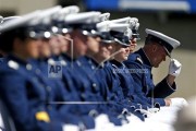 A graduating Air Force Academy cadet straightens his cap during the graduation ceremony for the class of 2015, at the U.S. Air Force Academy, in Colorado Springs, Colo., Thursday, May 28, 2015. (AP Photo/Brennan Linsley)