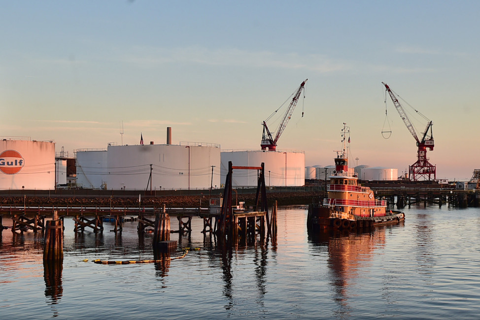 In this May 8, 2105 photo, a tug boat floats near storage tanks at the New Haven Port Authority in New Haven, Conn. New England's ports saw their national rankings in terms of total trade plummet since the 1970s. New Haven, ranked 33rd in the nation in 1972 with 13.1 million tons, ranked 57th in 2013 with only 8.4 million tons, according to the American Association of Port Authorities. (Catherine Avalone/New Haven Register via AP) MANDATORY CREDIT