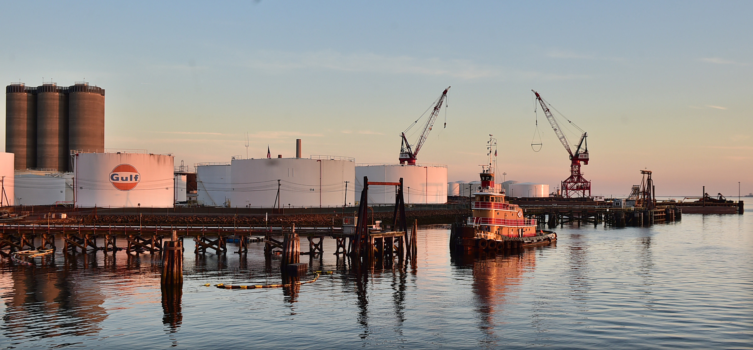 In this May 8, 2105 photo, a tug boat floats near storage tanks at the New Haven Port Authority in New Haven, Conn. New England's ports saw their national rankings in terms of total trade plummet since the 1970s. New Haven, ranked 33rd in the nation in 1972 with 13.1 million tons, ranked 57th in 2013 with only 8.4 million tons, according to the American Association of Port Authorities. (Catherine Avalone/New Haven Register via AP) MANDATORY CREDIT