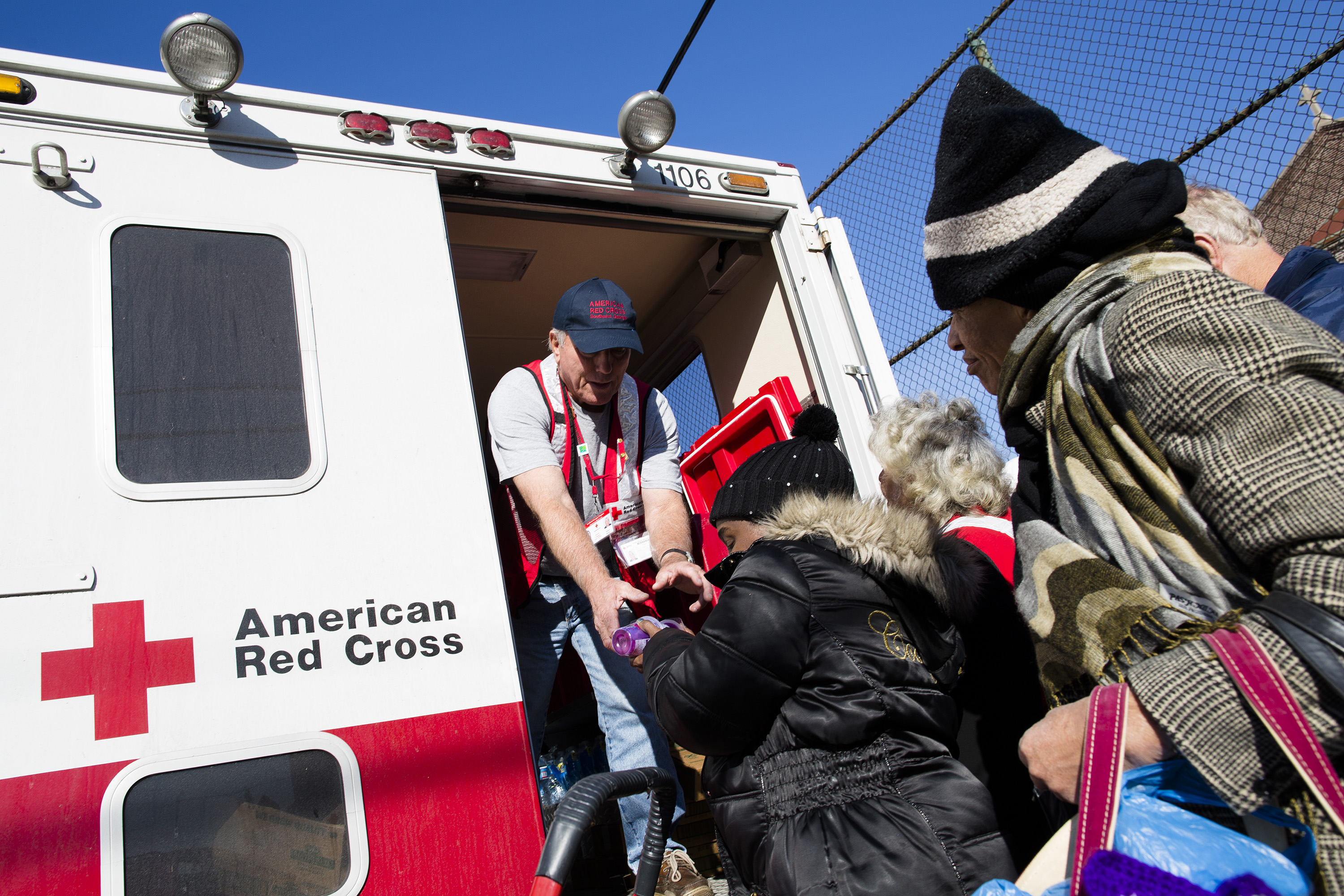 FILE - In this Friday, Nov. 9, 2012 file photo, a member of the American Red Cross distributes food to residents of Coney Island affected by Superstorm Sandy in the Brooklyn borough of New York. A year after receiving huge sums to respond to Superstorm Sandy, the American Red Cross experienced a 32 percent drop in charitable donations in 2014. It fell from ninth to 21st place among the nation's best-supported nonprofits _ its lowest ranking since The Chronicle of Philanthropy began an annual survey in 1991. (AP Photo/John Minchillo)