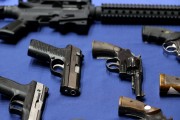 Guns seized by the police are displayed during a news conference in New York, Tuesday, Oct. 27, 2015. Officials announced charges in a gun trafficking case where more than 70 firearms were seized. (AP Photo/Seth Wenig)