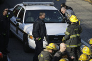 Investigators and firefighters work the scene of a fire and shooting Tuesday, Nov. 24, 2015, in Philadelphia. Police Department spokeswoman Leeloni Palmiero said its state police trooper has been shot in the shoulder after a fiery crash along Interstate 676. (AP Photo/Matt Rourke)