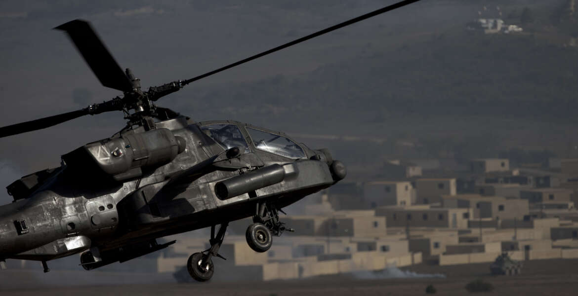 A US AH-64 Apache flies over the combat zone during a NATO military demonstration in Zaragoza, Spain, Wednesday Nov. 4, 2015. NATO is putting on its most fearsome display of military might in over a decade with soldiers, ships and planes meant to hone and test its abilities as well as send an unequivocal sign to Russia and other real or potential foes. For three weeks which started Oct. 21, more than 36,000 personnel from all 28 NATO allies and eight partner nations, 160 aircraft and 60 ships will be taking part in exercises across a wide swath of southern Europe from Portugal to Italy. (AP Photo/Abraham Caro Marin)