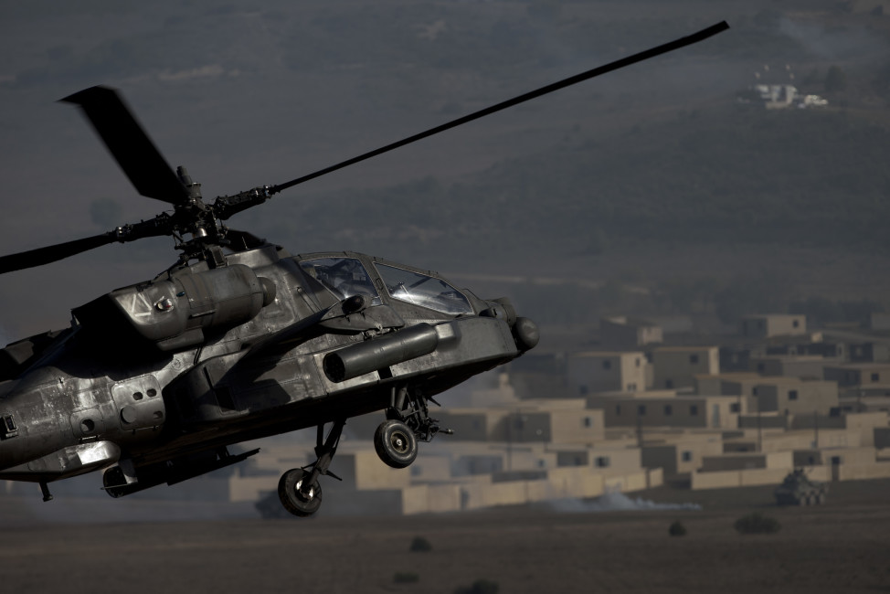 A US AH-64 Apache flies over the combat zone during a NATO military demonstration in Zaragoza, Spain, Wednesday Nov. 4, 2015. NATO is putting on its most fearsome display of military might in over a decade with soldiers, ships and planes meant to hone and test its abilities as well as send an unequivocal sign to Russia and other real or potential foes. For three weeks which started Oct. 21, more than 36,000 personnel from all 28 NATO allies and eight partner nations, 160 aircraft and 60 ships will be taking part in exercises across a wide swath of southern Europe from Portugal to Italy. (AP Photo/Abraham Caro Marin)