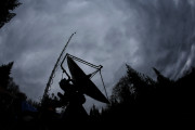 A truck-mounted radar instrument called the Doppler On Wheels is silhouetted against cloudy skies Friday, Nov. 6, 2015, on the banks of Lake Quinault near Amanda Park, Wash. Led by NASA and hosted by the University of Washington, a team of meteorologists and scientists is fanning out across one of the wettest places in the country in November to measure raindrops and snowdrops and attempt to validate, on the ground, how well global satellites measure precipitation from space. (AP Photo/Ted S. Warren)