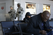 Security personnel walk round a terminal at LaGuardia Airport in New York, Wednesday, Nov. 25, 2015. An expanded version of America's annual Thanksgiving travel saga was under way Wednesday with gas prices low and terrorism fears high. An estimated 46.9 million Americans are expected to take a car, plane, bus or train at least 50 miles from home over the long holiday weekend, according to the motoring organization AAA. That would be an increase of more than 300,000 people over last year, and the most travelers since 2007. (AP Photo/Seth Wenig)