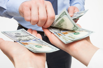 Human hands exchanging money