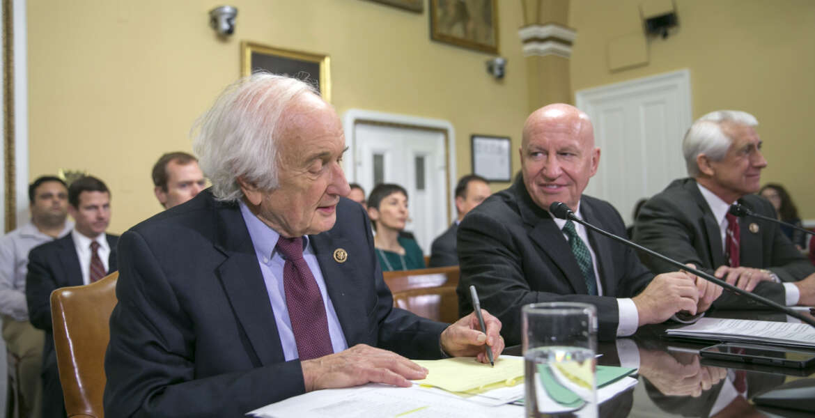 In this photo taken Dec. 10,2015, House Ways and Means Committee Chairman Rep. Kevin Brady, R-Texas, center, flanked by the committee's ranking member, Rep. Sander Levin, D-Mich., left, and  Rep. Dave Reichert, R-Wash., participate in a  House Rules Committee hearing on Capitol Hill in Washington. The House has approved a bill that would block U.S. negotiators from using trade agreements to cut greenhouse gas emissions.  (AP Photo/J. Scott Applewhite)
