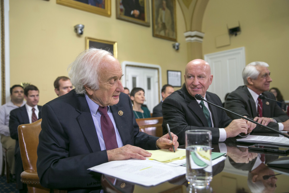 In this photo taken Dec. 10,2015, House Ways and Means Committee Chairman Rep. Kevin Brady, R-Texas, center, flanked by the committee's ranking member, Rep. Sander Levin, D-Mich., left, and  Rep. Dave Reichert, R-Wash., participate in a  House Rules Committee hearing on Capitol Hill in Washington. The House has approved a bill that would block U.S. negotiators from using trade agreements to cut greenhouse gas emissions.  (AP Photo/J. Scott Applewhite)