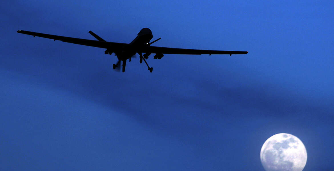 FILE - In this Jan. 31, 2010 file photo, an unmanned U.S. Predator drone flies over Kandahar Air Field, southern Afghanistan, on a moon-lit night.  Putting the U.S. military in charge of drone strikes in Iraq and Syria is leading to reduced congressional scrutiny.   Some officials and activists fear that means a greater risk of civilian casualties.   (AP Photo/Kirsty Wigglesworth, File)