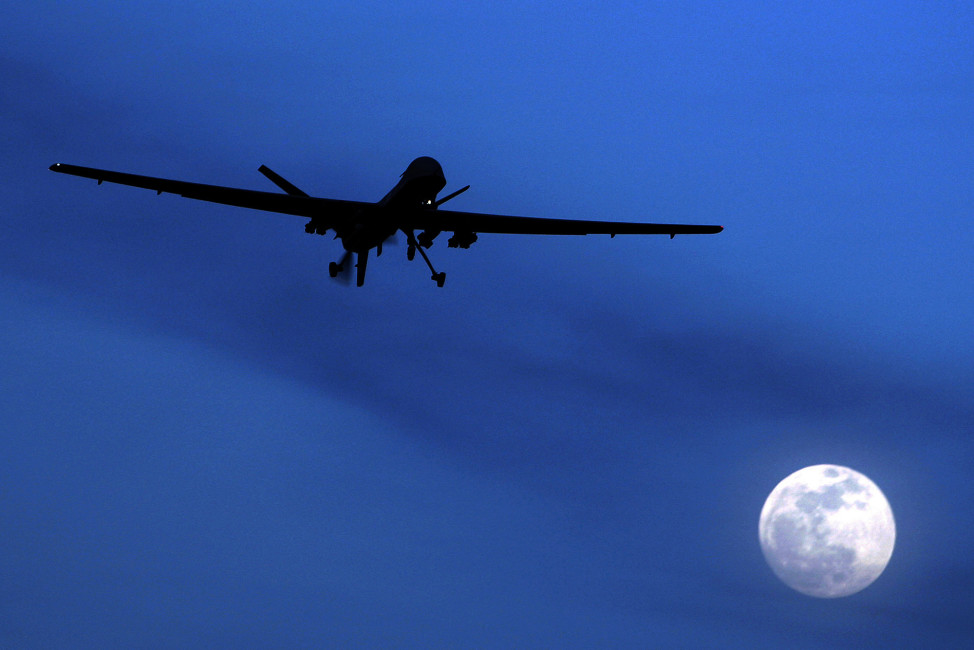 FILE - In this Jan. 31, 2010 file photo, an unmanned U.S. Predator drone flies over Kandahar Air Field, southern Afghanistan, on a moon-lit night.  Putting the U.S. military in charge of drone strikes in Iraq and Syria is leading to reduced congressional scrutiny.   Some officials and activists fear that means a greater risk of civilian casualties.   (AP Photo/Kirsty Wigglesworth, File)