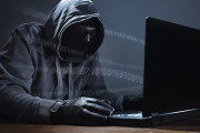 Hacker stealing data from a laptop