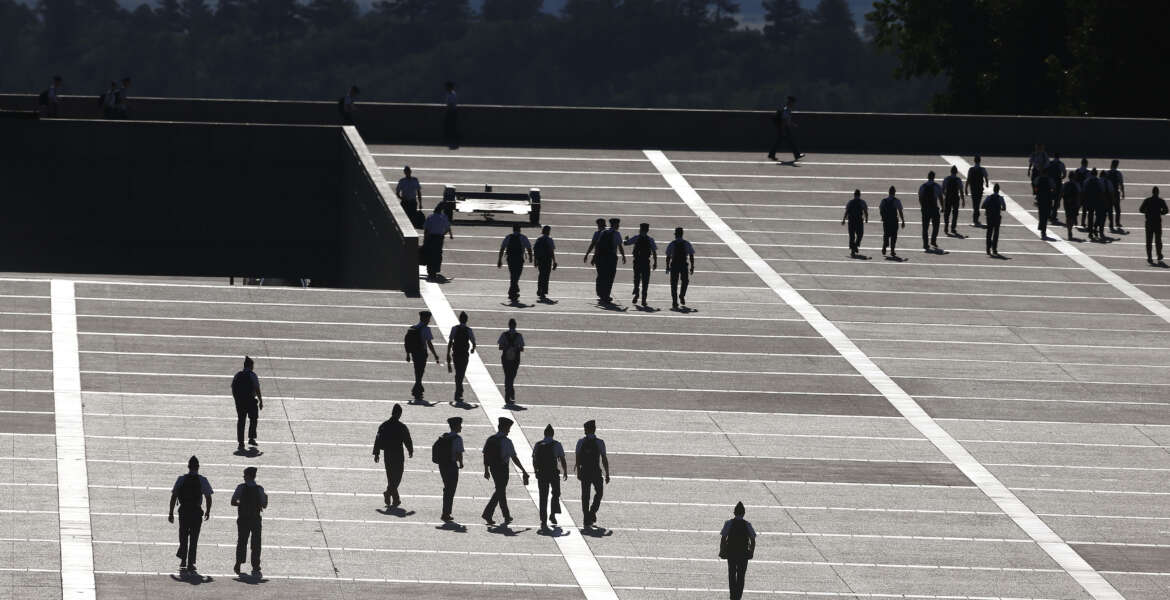 FILE - In this Aug. 13, 2014, file photo, cadets walk between classes on the Air Force Academy campus, near Colorado Springs, Colo. Reports of sexual assaults at the three military academies surged by more than 50 percent in the 2014-15 school year, and complaints of sexual harassment also spiked, according to Pentagon officials. (AP Photo/Brennan Linsley, File)