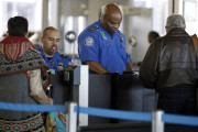 FILE - In this Nov. 25, 2015 file photo, Transportation Security Administration agents check travelers identifications at a security check point area in Terminal 3 at O'Hare International Airport in Chicago. Fliers who don't have the latest driver's licenses will have a two-year reprieve before their IDs are rejected at airport security checkpoints. Many travelers had been worried that the Transportation Security Administration would penalize them because of a federal law requiring the more-stringent IDs at the start of this year. (AP Photo/Nam Y. Huh, File)