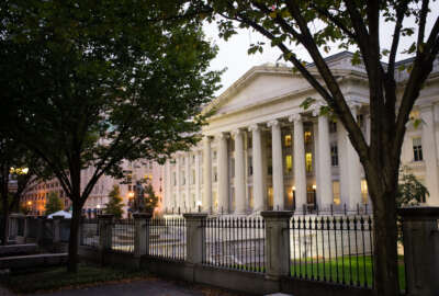 FILE - In this Wednesday, Oct. 16, 2013, file photo, the U.S. Treasury Building stands in Washington. On Tuesday, Feb. 16, 2016, the Treasury Department reports on foreign holdings of U.S. debt for December 2015. (AP Photo/J. David Ake, File)