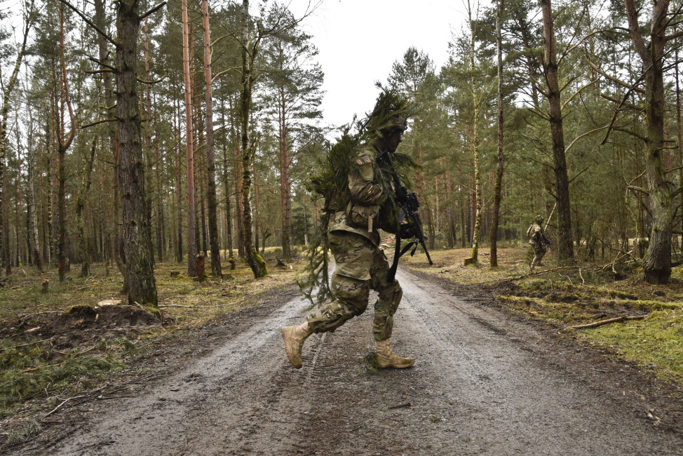 A Trooper assigned to Palehorse Troop, 4th Squadron, 2nd Cavalry Regiment, tactically crosses a road while proceeding to his fire team's next objective during their unit's live-fire exercise at the Grafenwoehr Training Area, located near Rose Barracks, Germany, Feb. 24, 2016. The unit used this exercise to update and train their Soldiers on tactical ground combat techniques while also conducting live-fire ranges on their FGM-148 Javelin missiles and their Stryker Mobile Gun System. (U.S. Army photo by Sgt. William A. Tanner)