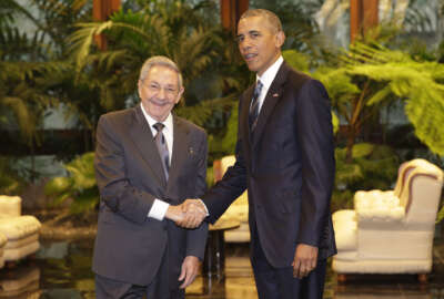 Cuban President Raul Castro, left, shakes hands with U.S. President Barack Obama during a meeting in Revolution Palace, Monday, March 21, 2016. Brushing past profound differences, President  Obama and President Castro sat down for a historic meeting, offering critical clues about whether Obama's sharp U-turn in policy will be fully reciprocated. (AP Photo/Ramon Espinosa)