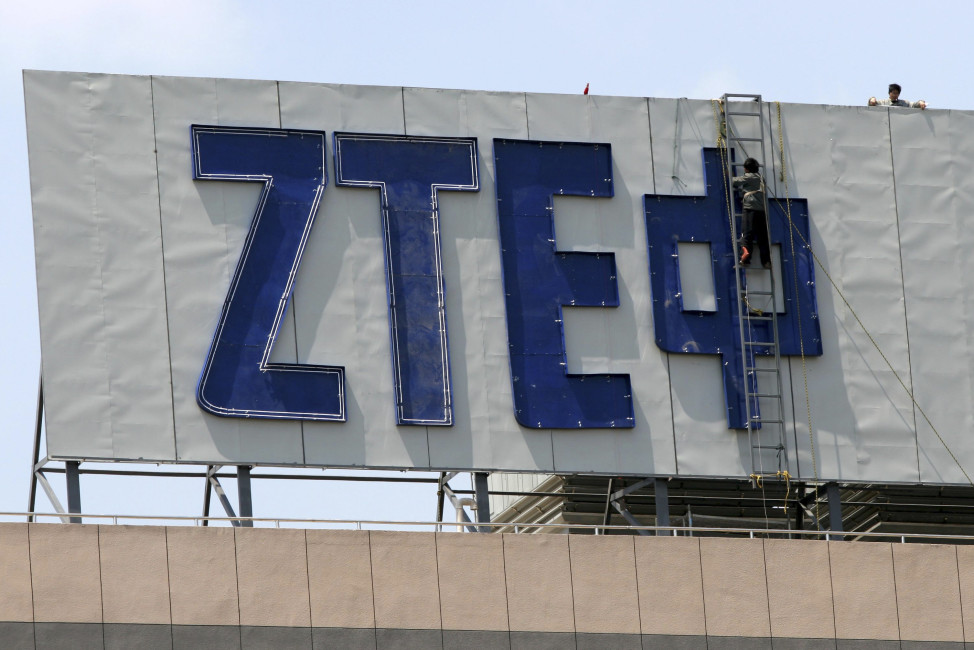 In this April 18, 2007 photo, workers install the logo for ZTE, a leading Chinese communications company, on top of an office building in Nanjing in eastern China's Jiangsu province. Washington has imposed restrictions on the ability of one of China's biggest telecoms equipment makers, ZTE Corp., to use American components after concluding the state-owned company improperly exported U.S. technology to Iran. Sanctions that took effect Tuesday, March 8, 2016, were imposed after ZTE was found to be "acting contrary to the national security or foreign policy interests" of the United States, the U.S. Commerce Department said. (Chinatopix via AP) CHINA OUT