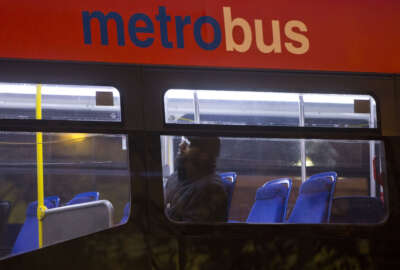 A man sits alone inside a Metrobus in downtown Washington, Wednesday, March 16, 2016. The Metro subway system that serves the nation's capital and its Virginia and Maryland suburbs shut down for a full-day for an emergency safety inspection of its third-rail power cables. Making for unusual commute, as the lack of service is forcing some people on the roads, while others are staying home or teleworking. (AP Photo/Pablo Martinez Monsivais)