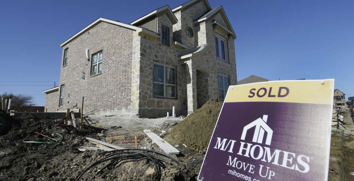In this Tuesday, Feb. 2, 2016, photo, a sold sign sits next to a house under the final stages of construction in Plano, Texas. On Thursday, March 10, 2016, Freddie Mac reports on the week’s average U.S. mortgage rates. (AP Photo/LM Otero)