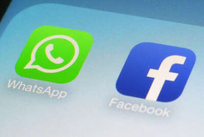 FILE - This Feb. 19, 2014, file photo, shows WhatsApp and Facebook app icons on a smartphone in New York. The government’s fight with Apple over an encrypted iPhone may be the first of many battles in a broader war over who gets access to individuals’ data, as more tech companies offer encrypted messaging and other services. WhatsApp, the globally popular messaging system owned by Facebook, has already run into trouble with Brazilian authorities, who arrested a Facebook executive earlier in March 2016 after the company said it had no way to unscramble a user’s encrypted messages. (AP Photo/Patrick Sison, File)