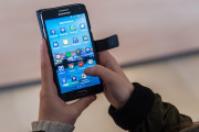 A woman uses an Android smartphone in Brussels on Wednesday April 20, 2016. The European Union is broadening its battle with Google, alleging that the technology giant rigs the global market for mobile apps by making its Android operating system give preferential treatment to its own products. EU Antitrust Commissioner Margrethe Vestager said that "Google's behavior denies consumers a wider choice of mobile apps and services and stands in the way of innovation." (AP Photo/Geert Vanden Wijngaert)