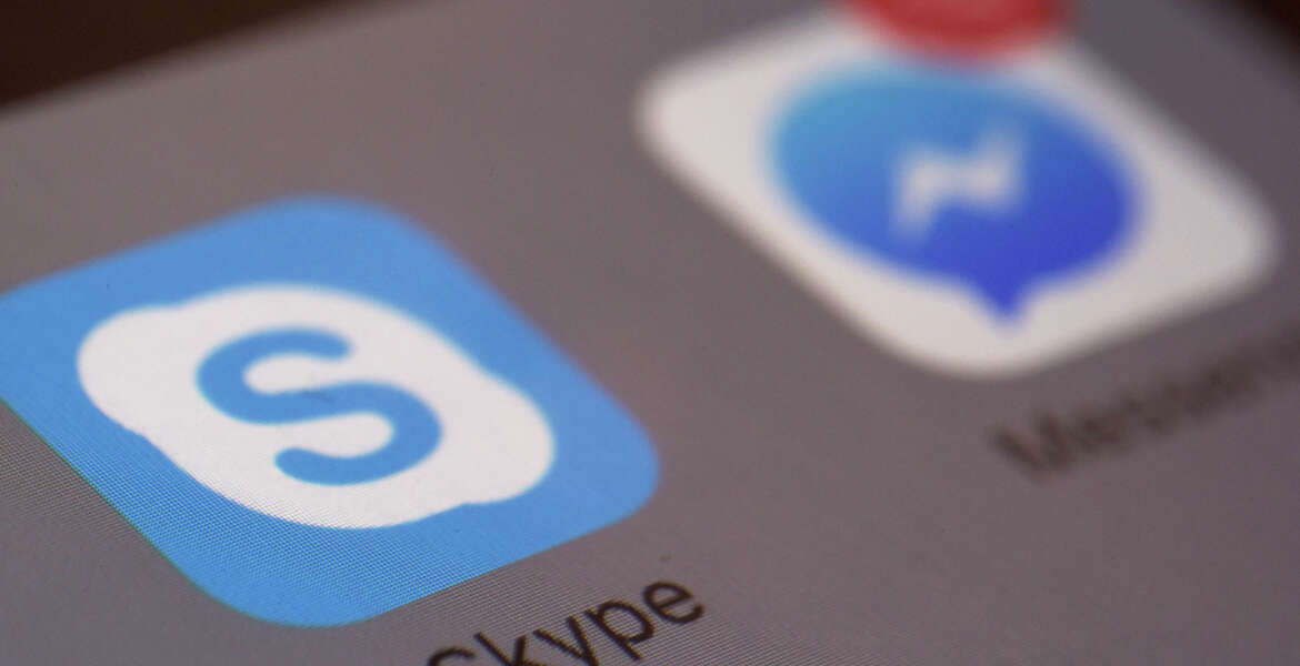 This Saturday, April 9, 2016 photo shows the icons for Microsoft's Skype and Facebook's Messenger apps on a smartphone in New York. In coming months, people who use Messenger, Skype and Canada's Kik for online chats can expect to see all kinds of businesses offering information and other services with the help of messaging 
