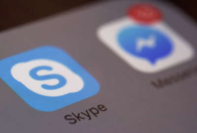 This Saturday, April 9, 2016 photo shows the icons for Microsoft's Skype and Facebook's Messenger apps on a smartphone in New York. In coming months, people who use Messenger, Skype and Canada's Kik for online chats can expect to see all kinds of businesses offering information and other services with the help of messaging 