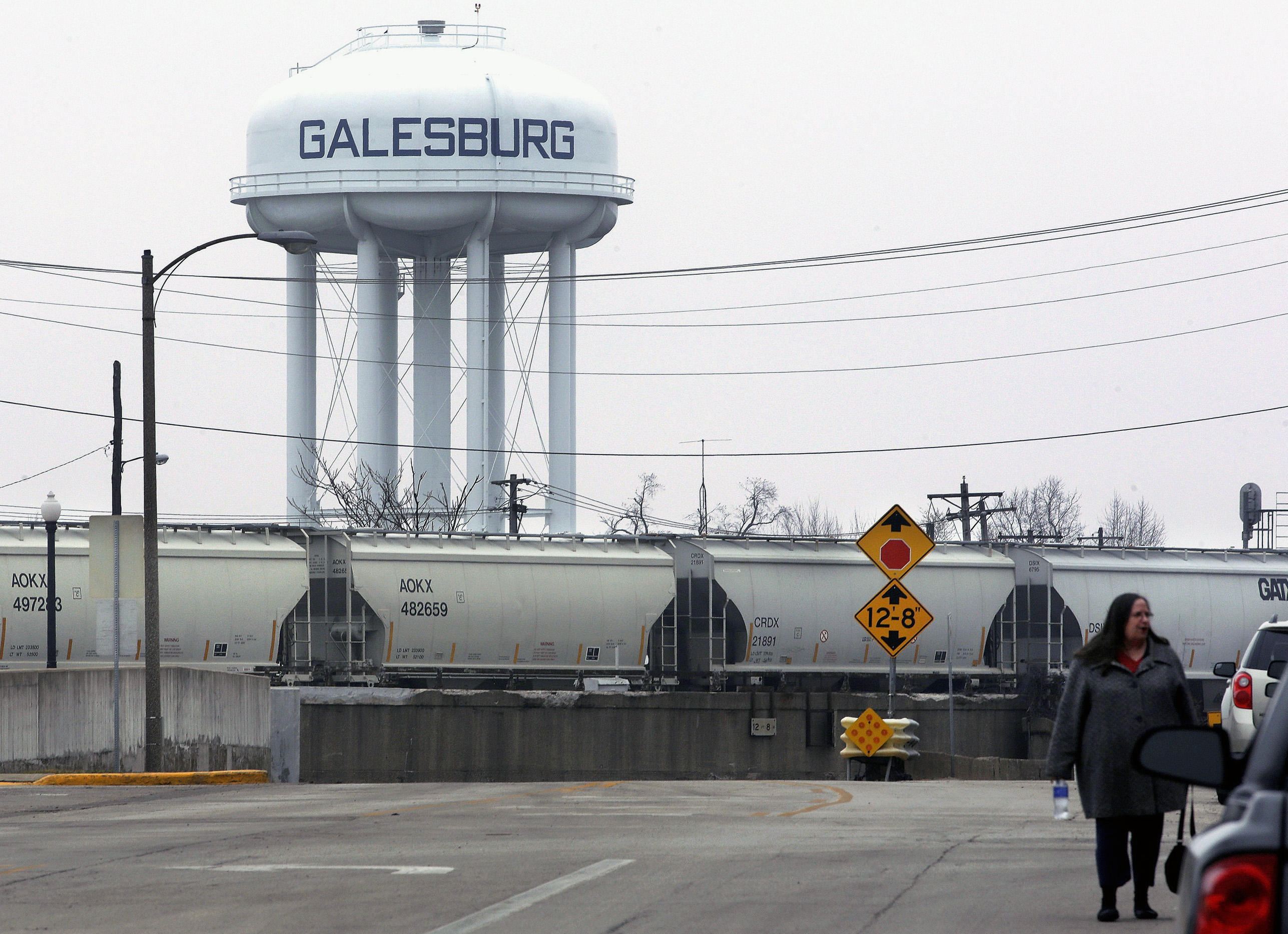 ADVANCE FOR RELEASE SATURDAY, APRIL 9, 2016, AT 10:00 A.M. EDT - In this Wednesday, March 9, 2016 photo, a train passes the water tower in downtown Galesburg, Ill. Galesburg offers just one example of how the problem of lead-tainted drinking water goes far beyond Flint, Mich., the former auto manufacturing center where the issue exploded into a public health emergency when the city’s entire water system was declared unsafe. (AP Photo/Seth Perlman)