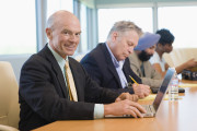 Businessman Using Laptop Besides Multiethnic Colleagues