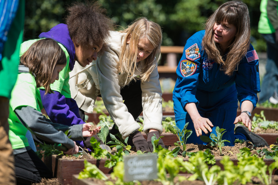 NASA Deputy Administrator Dava Newman, second right, plants seedlings with students who have their own school gardening programs, at the White House Kitchen Garden on Tuesday, April 5, 2016 in Washington, DC. Mrs. Obama invited NASA and students of schools across the U.S. to participate in planting her final garden as First Lady. Photo Credit: (NASA/Aubrey Gemignani)