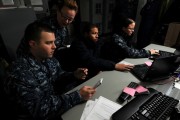 Sailors work together to assess the security of the computer networks aboard the aircraft carrier USS George H.W. Bush (CVN 77), Jan 17, 2013.