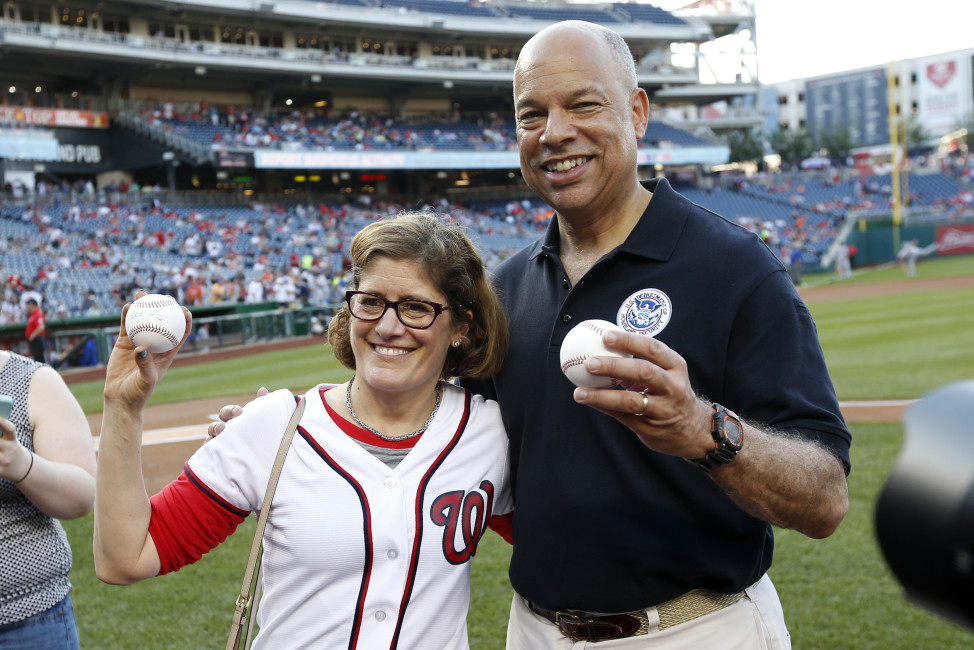 Beth Cobert, left, Acting Director for the United States Office of Personnel Management, and Homeland Security Secretary Jeh Johnson, hold up the balls they used for their ceremonial first pitches before a baseball game between the Washington Nationals and the New York Mets t Nationals Park, Tuesday, May 24, 2016, in Washington. (AP Photo/Alex Brandon)