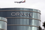 FILE - In this Tuesday, March 20, 2012, file photo, a plane flies over Oracle headquarters in Redwood City, Calif. On Thursday, May 26, 2016, a federal jury sided with Google in a long-running legal battle with tech industry rival Oracle in a complex copyright case that was closely watched in Silicon Valley. Oracle had said Google stole some of its software to create Android, the world's most popular smartphone operating system. Oracle is vowing to appeal. (AP Photo/Paul Sakuma, File)