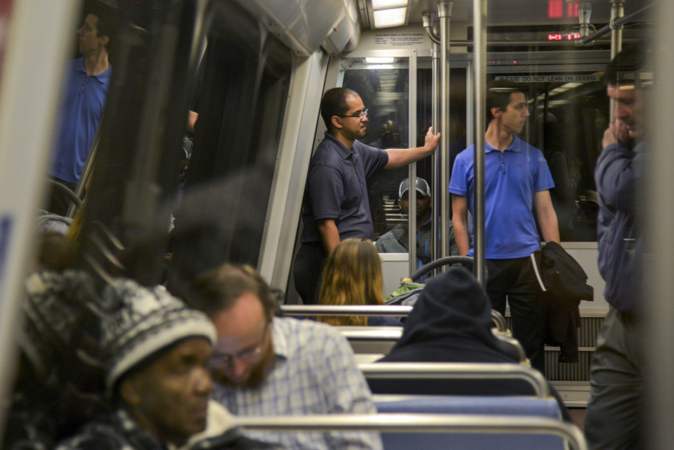 In this Thursday, April 28, 2016 photo, Roger Bowles, center, and Stephen Repetski, center right, ride a blue line Metro train from the McPherson Square Station to Crystal City in Washington. The two are part of a group of hobbyists who monitor the rails for any anomalies or abnormalities and provide real-time info of problems. (Jahi Chikwendiu/The Washington Post via AP) MANDATORY CREDIT