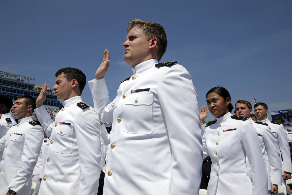 Graduating U.S. Naval Academy Midshipmen raise their right hands as they are commissioned as ensigns in the U.S. Navy during the Academy's graduation and commissioning ceremony in Annapolis, Md., Friday, May 27, 2016. (AP Photo/Patrick Semansky)