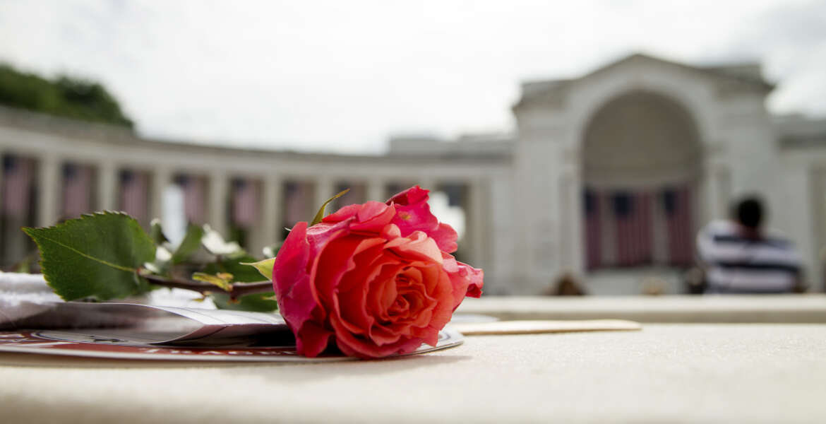A rose is visible on a seat before President Barack Obama speaks at the Memorial Amphitheater of Arlington National Cemetery, in Arlington, Va., Monday, May 30, 2016, during a Memorial Day ceremony. (AP Photo/Andrew Harnik)