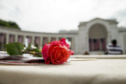 A rose is visible on a seat before President Barack Obama speaks at the Memorial Amphitheater of Arlington National Cemetery, in Arlington, Va., Monday, May 30, 2016, during a Memorial Day ceremony. (AP Photo/Andrew Harnik)