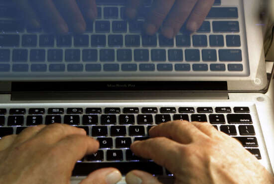 FILE - In this Feb. 27, 2013, file photo illustration, hands type on a computer keyboard in Los Angeles. Spring is a great time to clear out your digital clutter and make sure that you're adequately protected against hackers. A personal cybersecurity clean up should involve evaluating all your passwords, updating your software and taking stock of exactly where all your personal information is stored. (AP Photo/Damian Dovarganes, File)