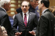 U.S. Department of Veterans Affairs for Health Undersecretary Dr. David Shulkin, center, talks with attendees prior to testifying about the current state of the VA Medical Center in Phoenix at a Senate Veterans' Affairs Committee field hearing Monday, Dec. 14, 2015, in Gilbert, Ariz. (AP Photo/Ross D. Franklin)