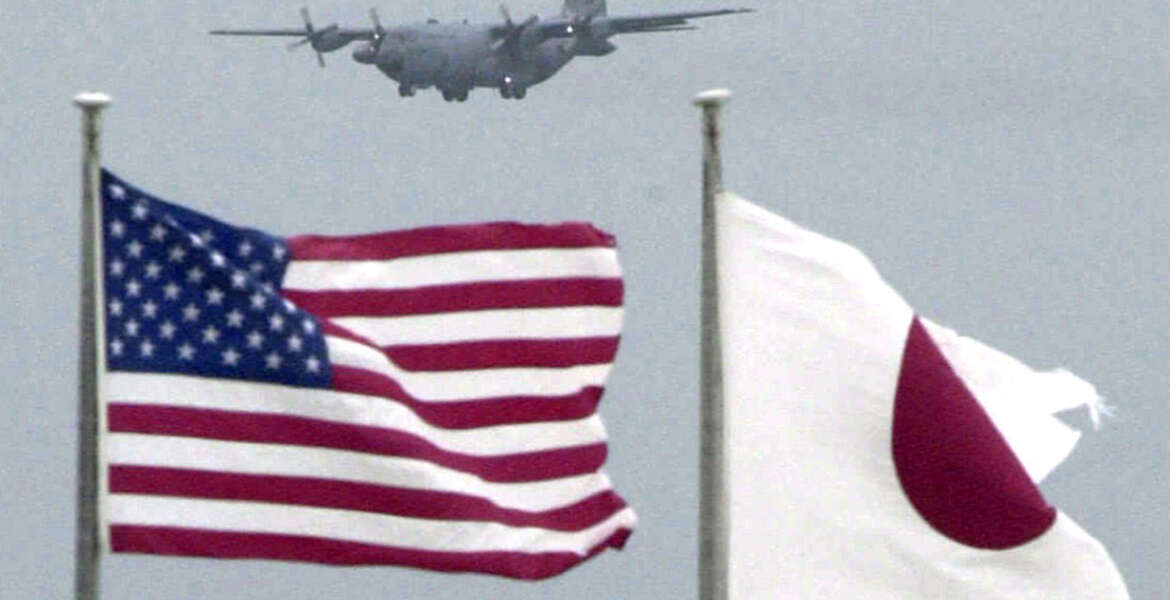 In this Sept. 23, 2001 photo,   flags of U.S. and Japan flutter in U.S. Kadena Air Base on the southern island of Okinawa in Japan.   An American sailor has tapped a cloud-based technology for mobile phones to make it easier to have volunteers take turns driving drunk friends home, an initiative that has curtailed drunken driving among the Navy ranks. The effort, tested at the Naval Sea Systems Command in Charleston, South Carolina, from February, 2016 could also help ease tensions on the southwestern Japanese island of Okinawa, where most of the U.S. troops in Japan are assigned. (Kyodo News via AP) JAPAN OUT, CREDIT MANDATORY