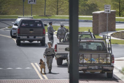 Security personnel patrol outside the Malcolm Grow Medical facility on Andrews AFB in Morningside, Md., when the base was placed on lockdown about 9 a.m. after an active shooter was reported, Thursday, June 30, 2016. Officials say reports of an active shooter at the military post stemmed from someone who made a distress call Thursday after seeing security forces doing a routine inspection.   (Linda Davidson/The Washington Post via AP) /The Washington Post via AP)  WASHINGTON TIMES OUT; NEW YORK TIMES OUT;THE WASHINGTON EXAMINER AND USA TODAY OUT; MAGS OUT; NO SALES; MANDATORY CREDIT