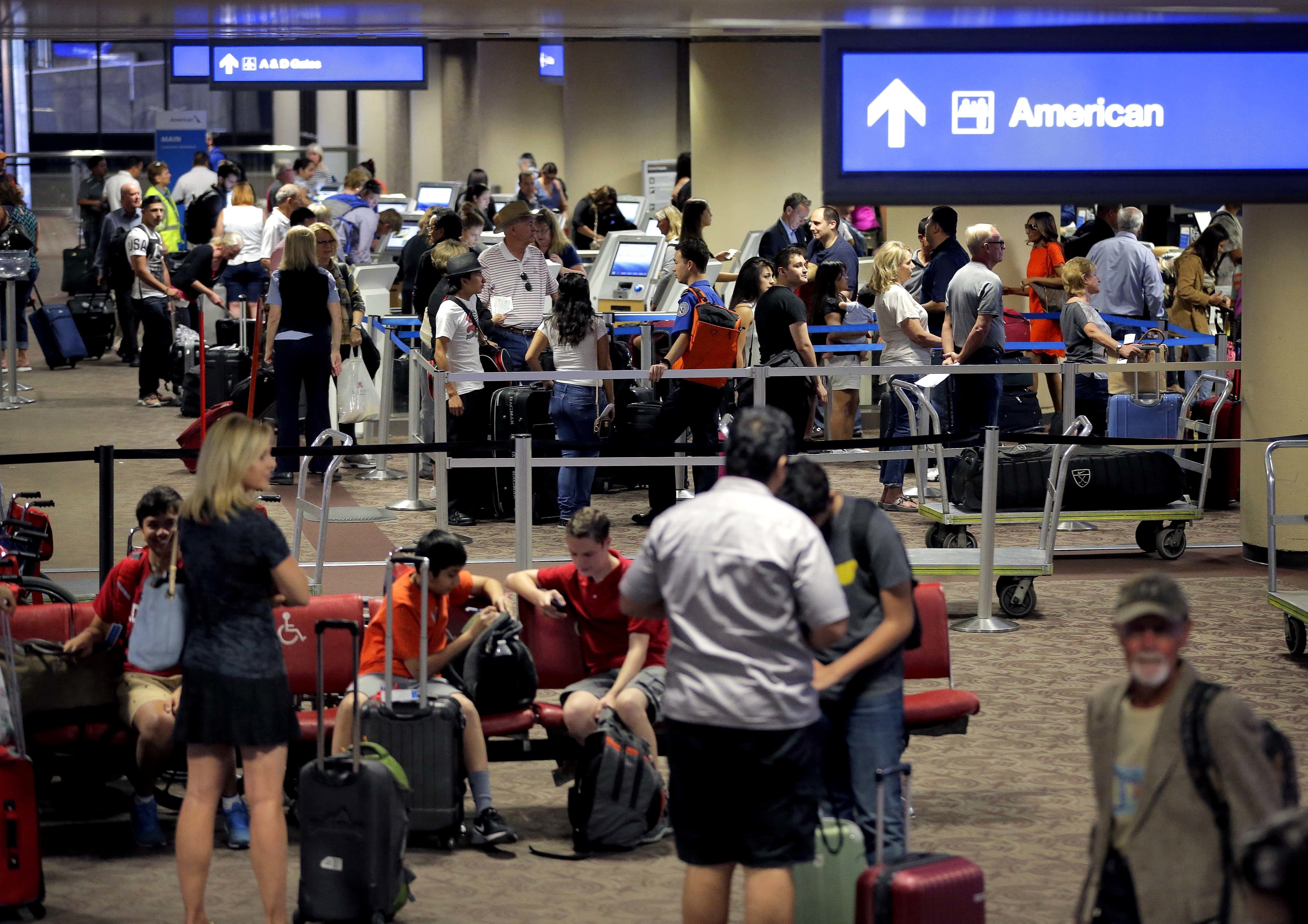 FILE - In this May 27, 2016 file photo, passengers line up to check in before their flight at Sky Harbor International Airport in Phoenix. Significant progress has been made on shortening screening lines since earlier this spring when airlines reported thousands of frustrated passengers were missing flights, the head of the Transportation Security Administration said Tuesday, June 7, 2016. (AP Photo/Matt York, File)